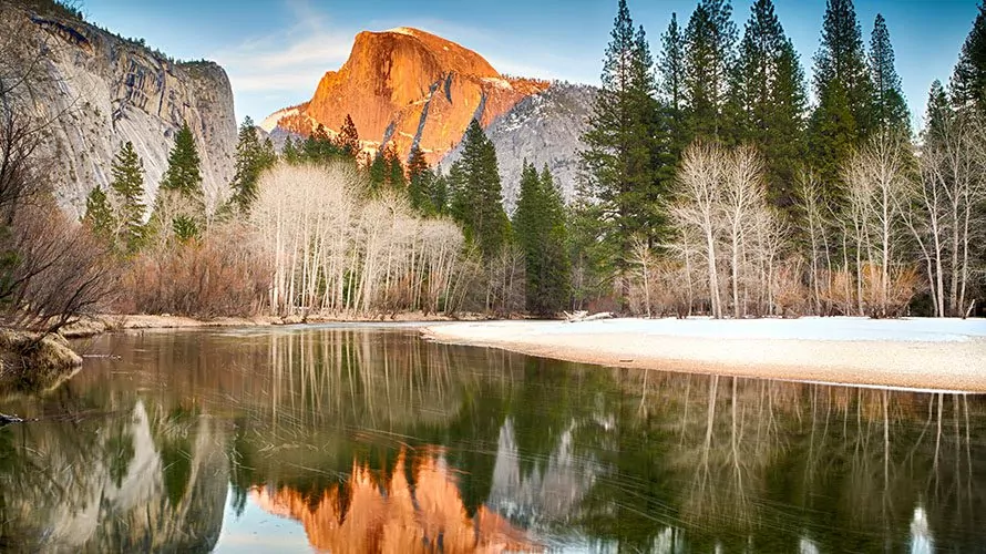 El cap aglow and reflected in the lake below during winter