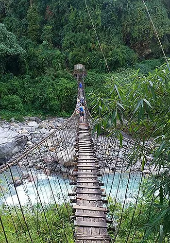 Wooden suspension bridge over river