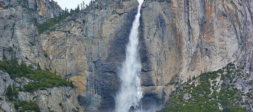 Huge waterfall between rocky mountains