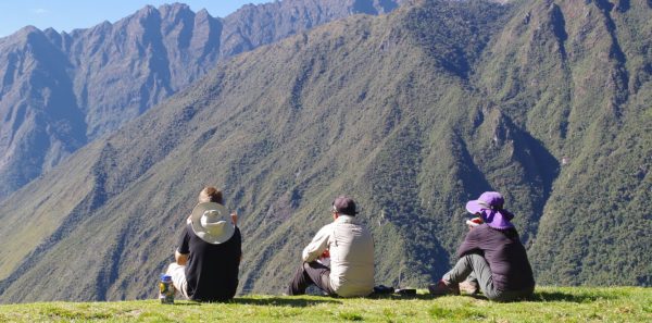 Three hikers overlooking mountain