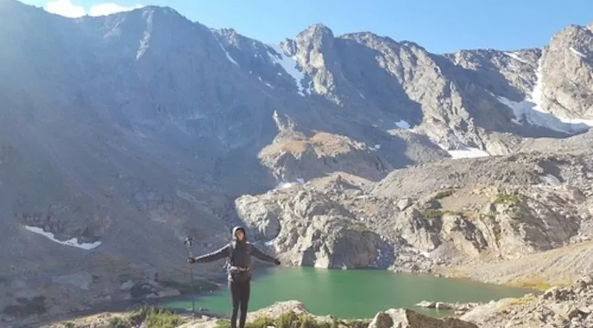 Hiker in front of sky pond