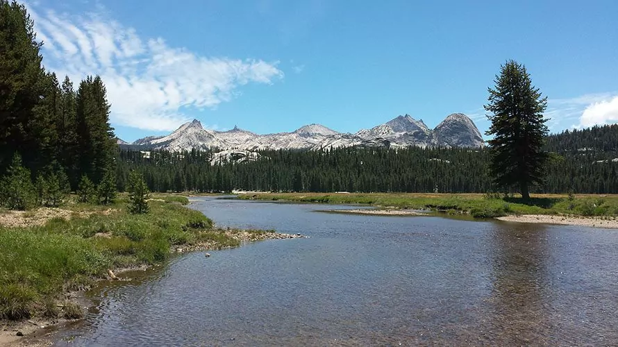 Large calm river with mountains in distance