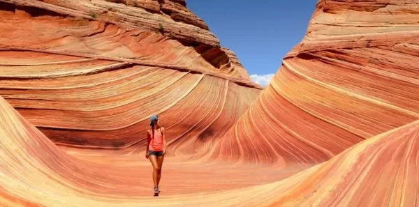 Woman walking through navajo sandstone