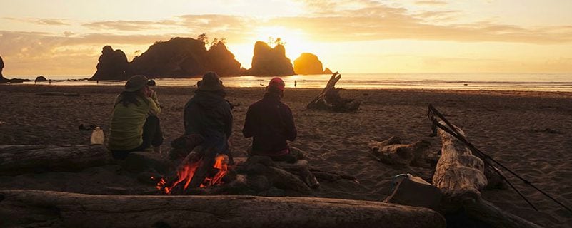 Hikers on the shore sunset