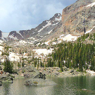 The granite rock formations dappled in snow and pine trees in Rocky Mountain National Park