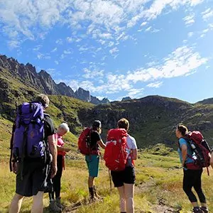 group of backpackers in field in Norway