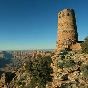 The Grand Canyon's Desert Tower with blue skies and lush foliage