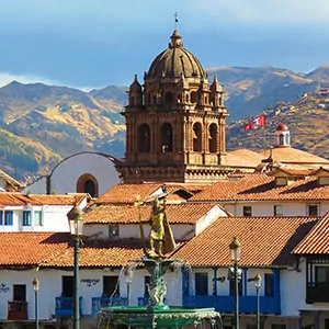 A church rises above the rest of the city buildings in Peru