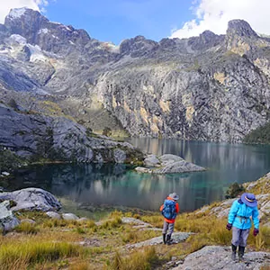 Hikers take in all the glory of high alpine lakes and rugged mountain landscapes in Peru