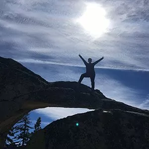 A hiker strikes a pose at the summit Yosemite National Park