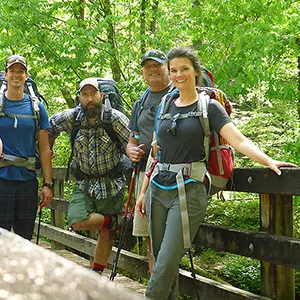 Hikers pose on a bridge in the Great Smoky Mountains
