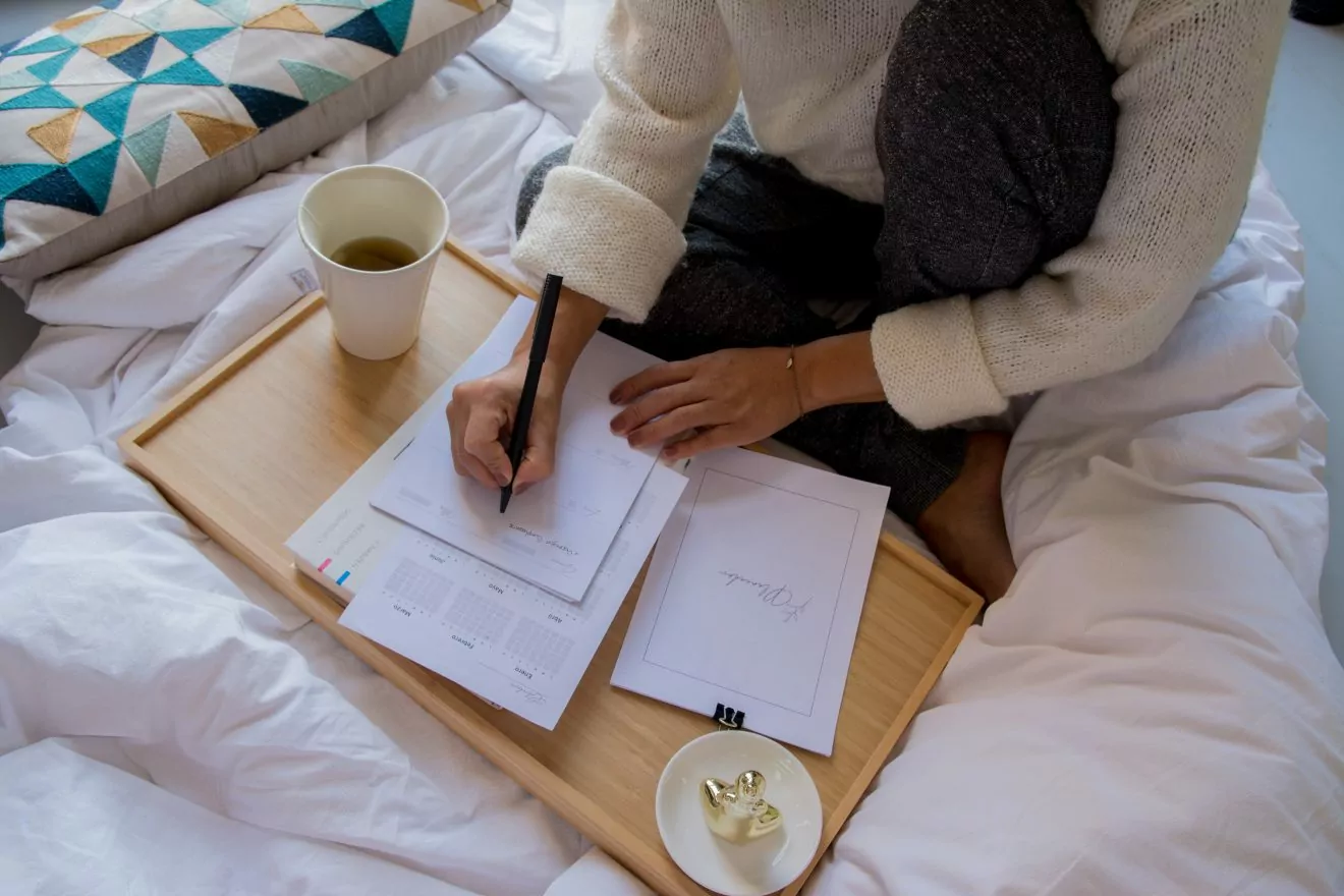 women on bed planning her training schedule