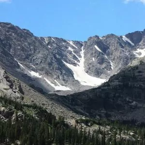 Snow slowly melts under the blue bird sunny skies in Rocky Mountain National Park