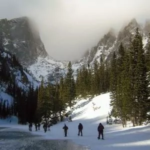 Snowshoers descend steep terrain in Rocky Mountain National Park
