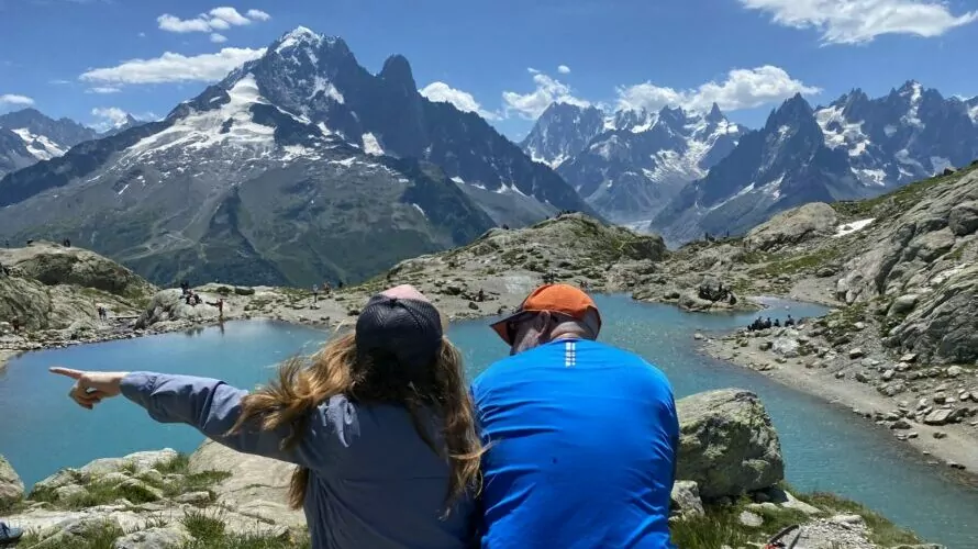 hiking couple enjoying the view at a mountain lake