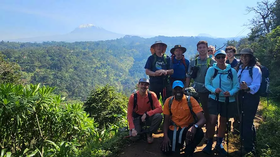 Wildland Trekking guests in rain forest with Kilimanjaro behind