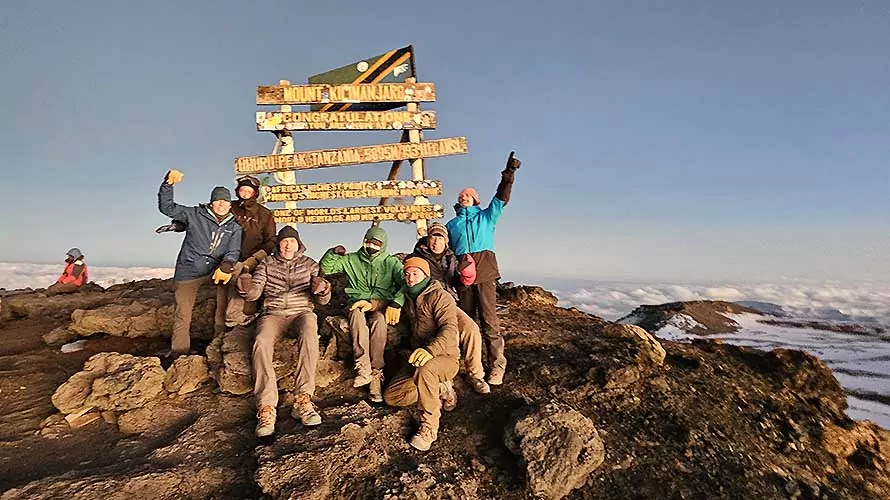 Wildland Trekking guests celebrating on the summit of Kilimanjaro