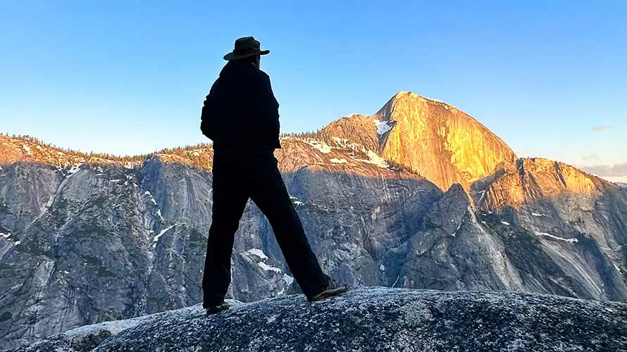 Man standing across from Half Dome at Snow Creek in Yosemite