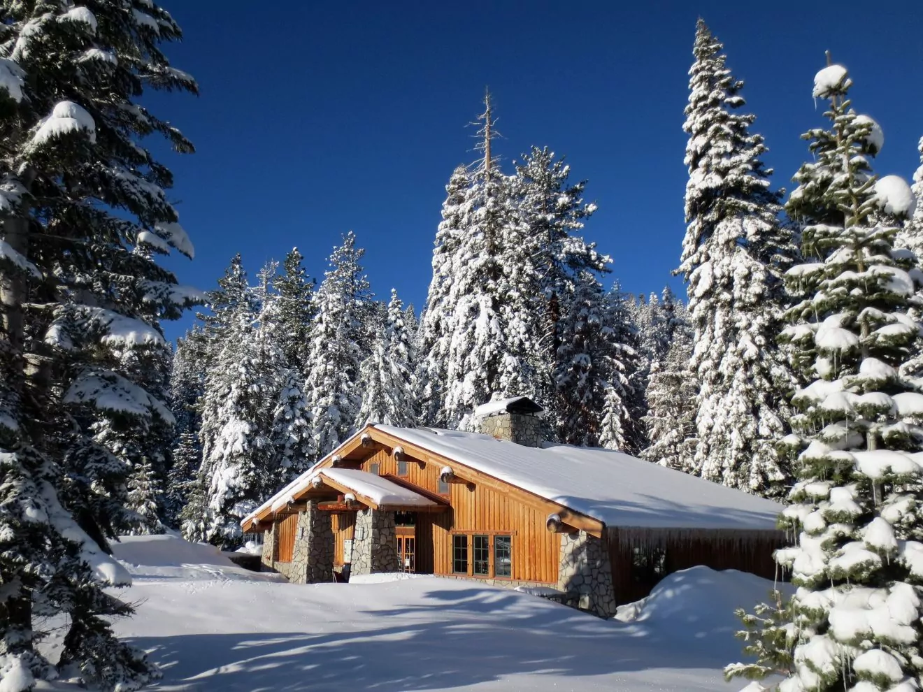 Glacier Point Ski Hut under a blanket of snow in Yosemite National Park. 