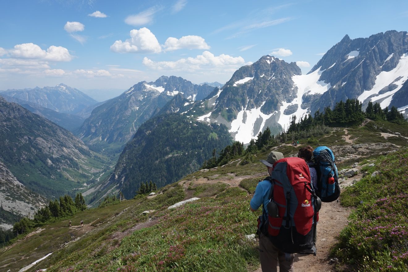Two backpackers overlooking the alpine scenery in the North Cascades