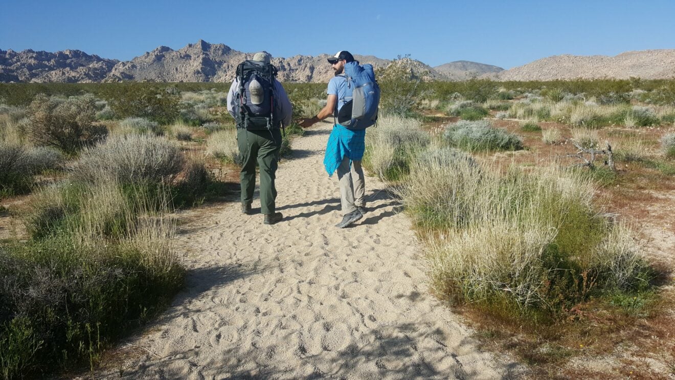 Two hikers discuss the trail in Joshua Tree National Park