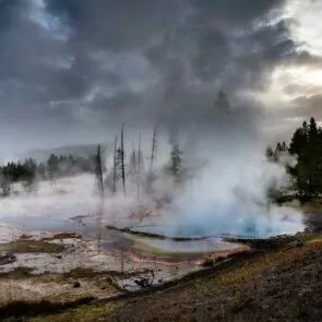 Yellowstone in April backcountry backpacking snow geyser geothermal feature snow dirt steam water