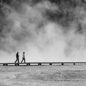 hiking in Yellowstone in august hot spring board walk man hike trail