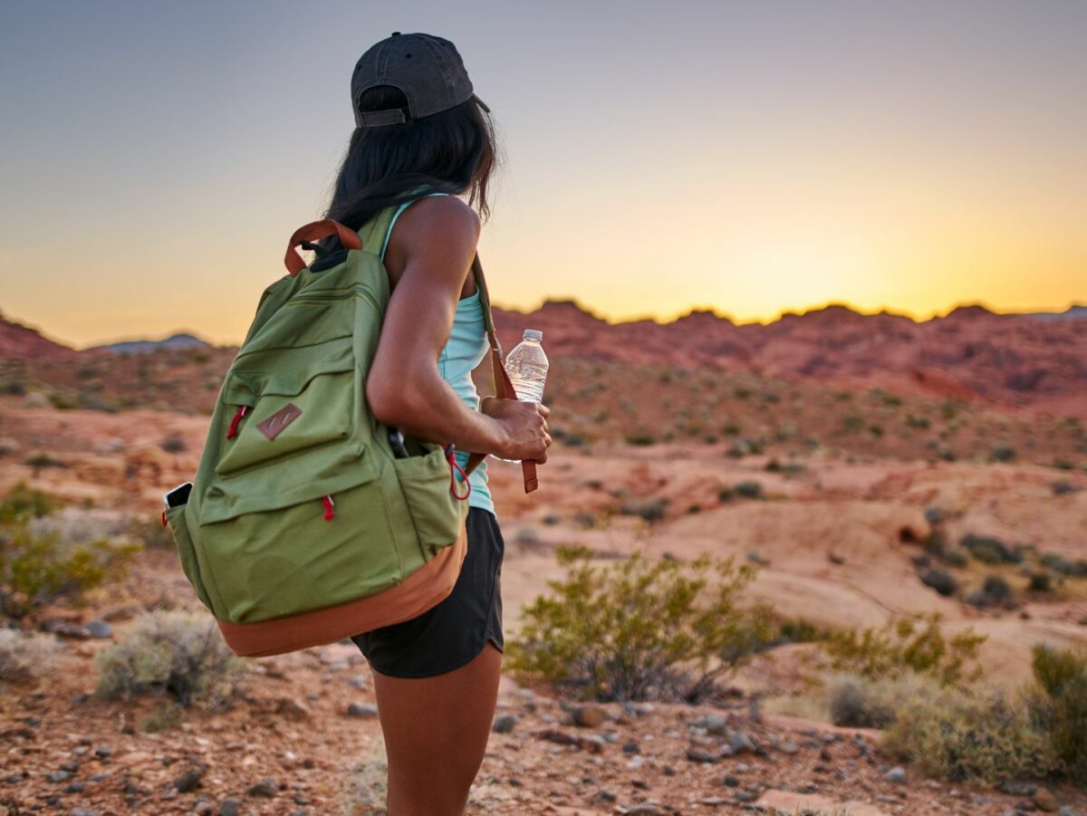 black female hiker in the desert at sunset