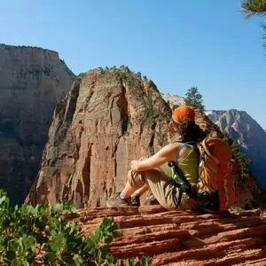 Zion in July backpacking women rest overlook cliff