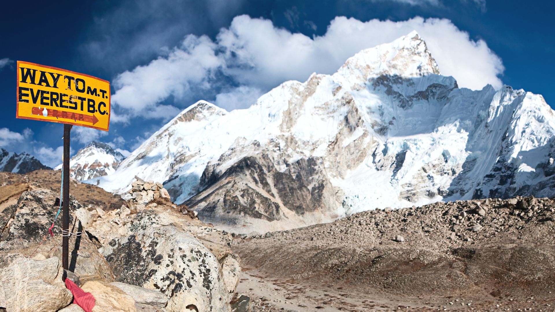 Sign on snowy mountain trail reads "Way to M.T. Everest B.C." 