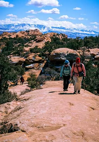 Two hikers on the Devils Garden Trail in Arches National Park, Utah