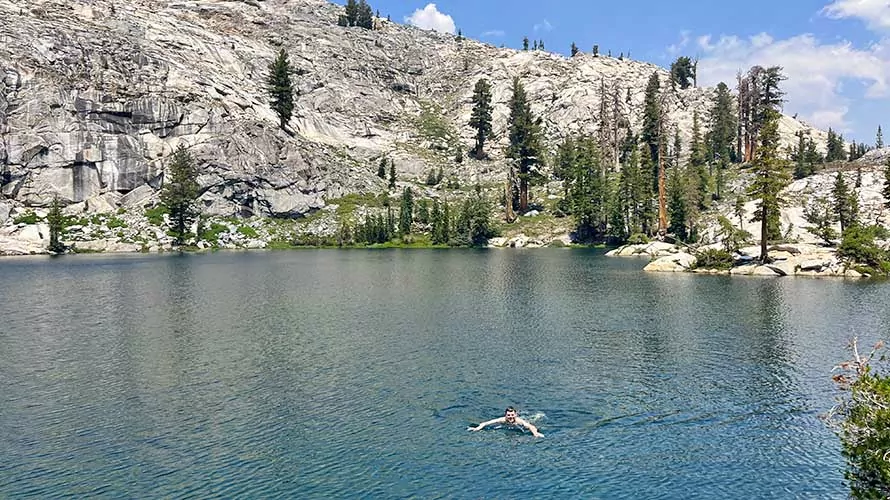 Swimmer in an alpine lake along the John Muir Trail, California
