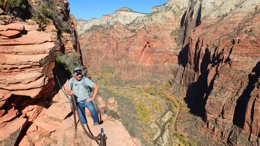 Hiker holds on to the chains of Angel's Landing in Zion National Park
