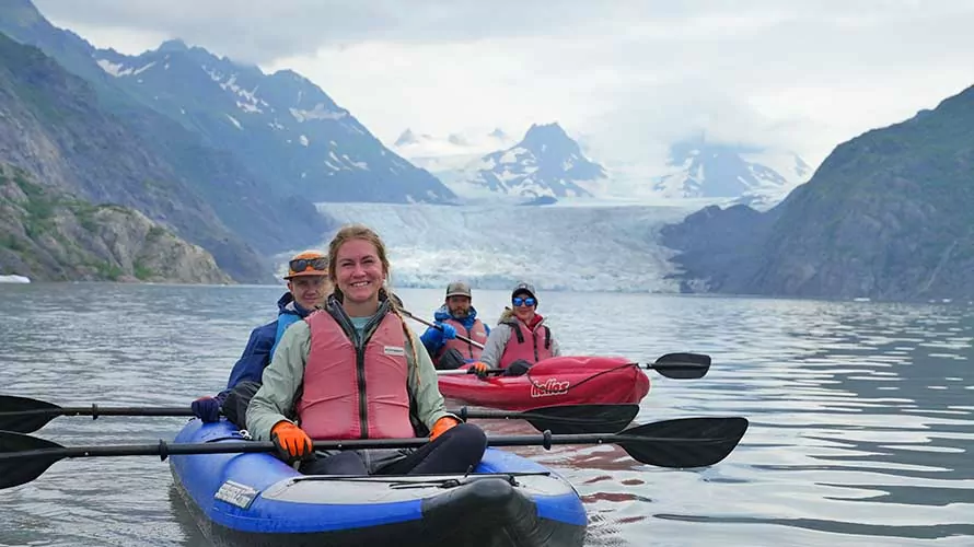 Kayakers in Kenai with glacier behind them