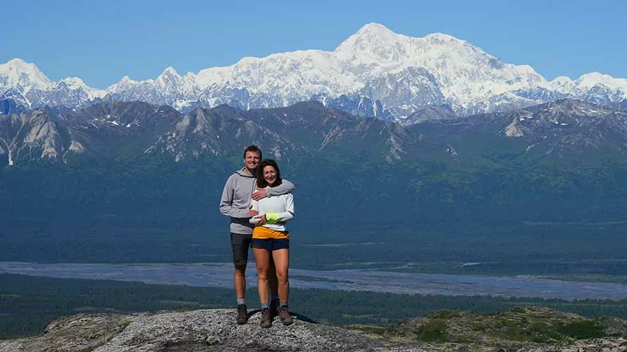 Couple embracing in front of Denali, Kesugi Ridge, Alaska