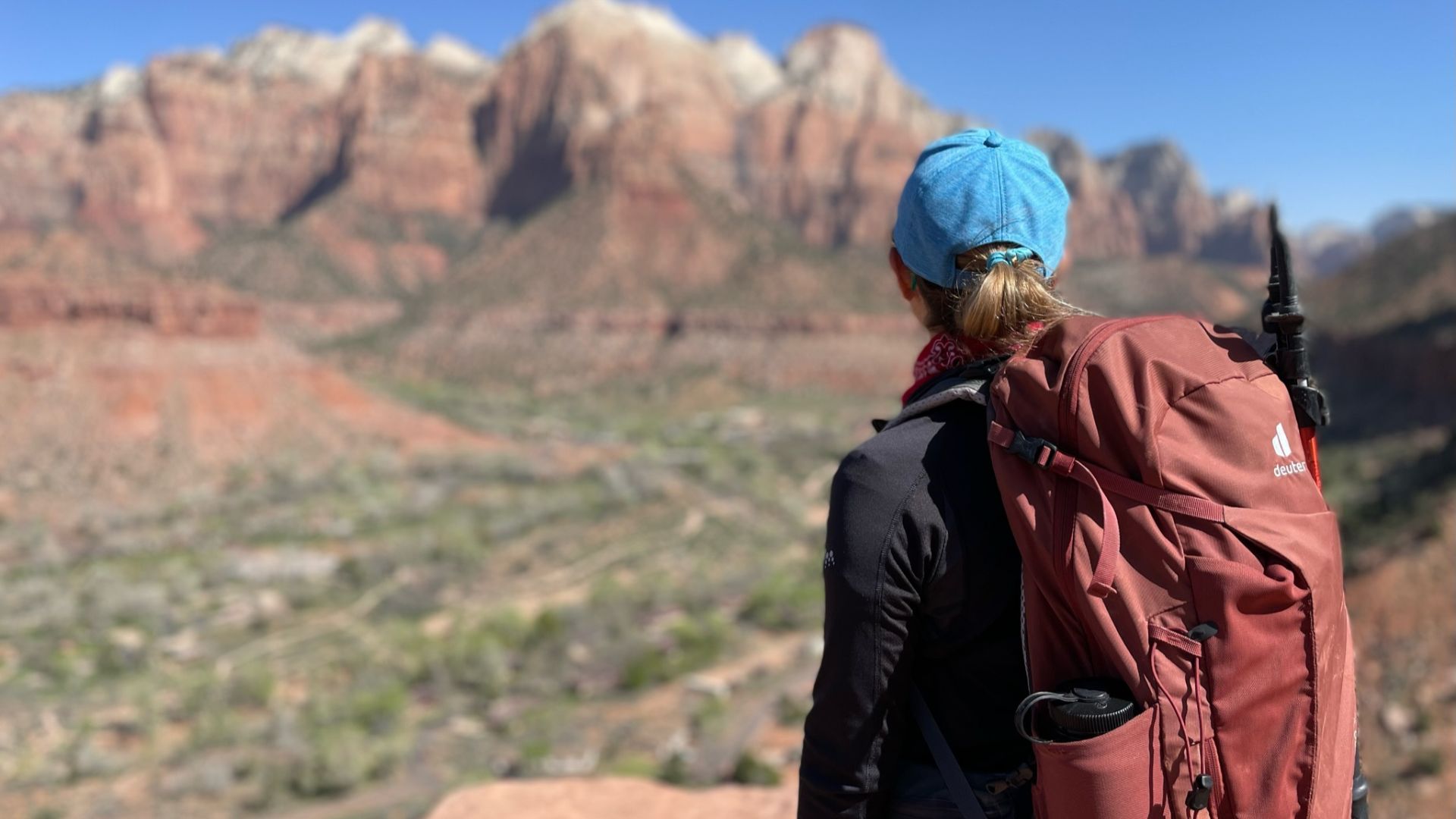 backpacker looks out over red rock view in sedona