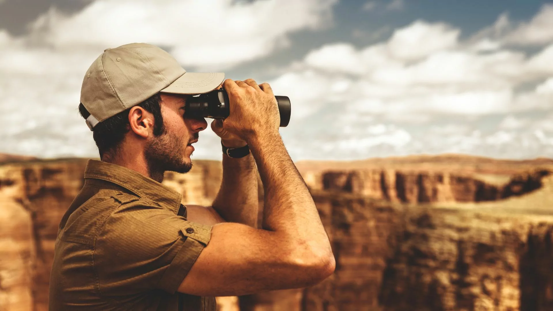 outdoor professional looks through binoculars