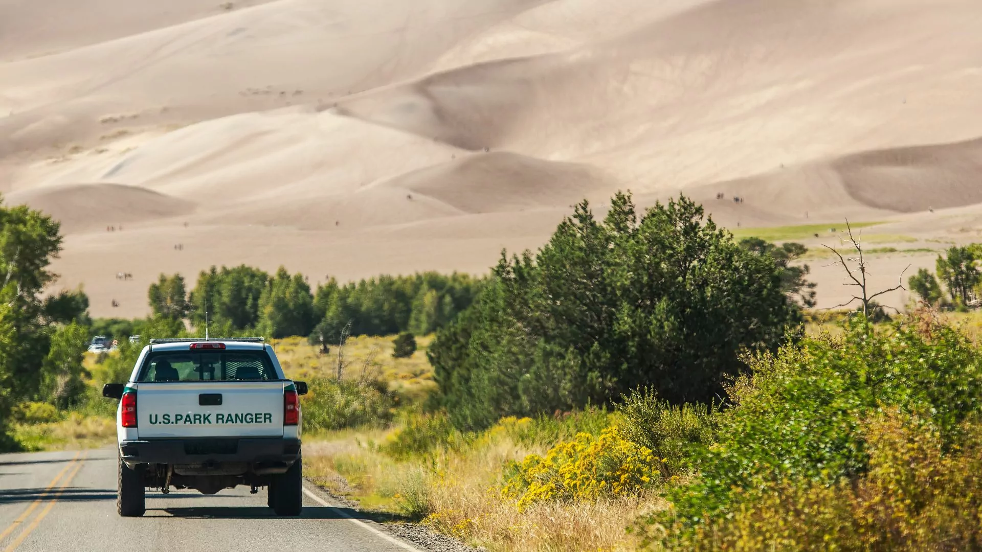 Park service vehicle drives into the distance