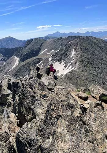 Wildland Trekking guest on rocky ridgeline in Rocky Mountain National Park