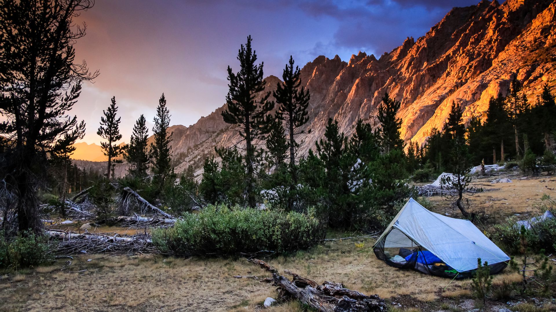 A backpacking tent sits at sunset on California's John Muir Trail