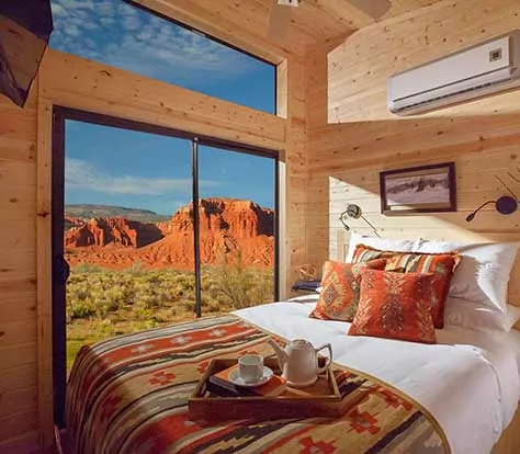 Gorgeous hotel room wth red cliffs outside the window of Capitol Reef Resort