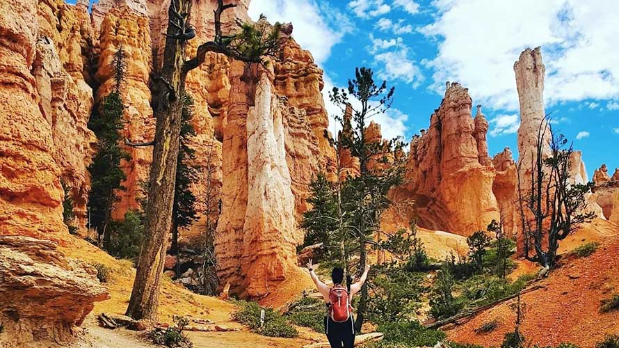 Woman raising arms in gratitude for Bryce Canyon National Park