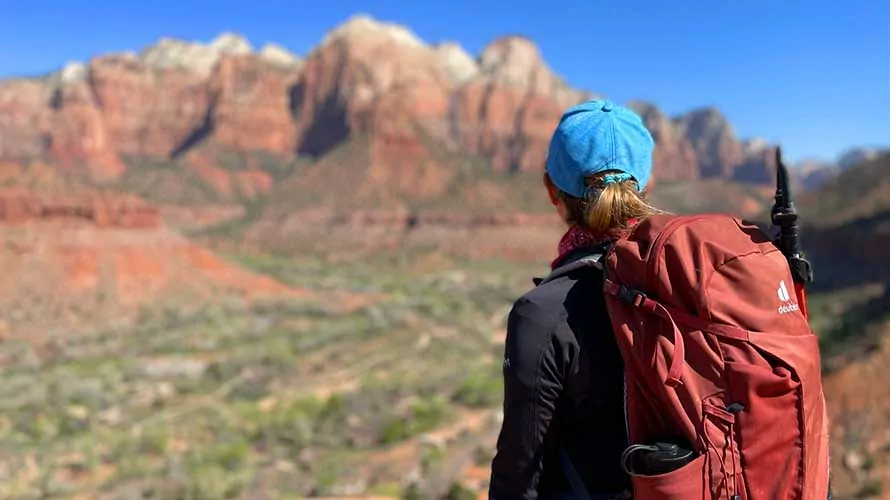 Woman hiker staring at the cliffs of Zion National Park
