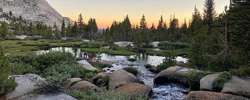 Mountain stream, meadows and sunset in Yosemite National Park