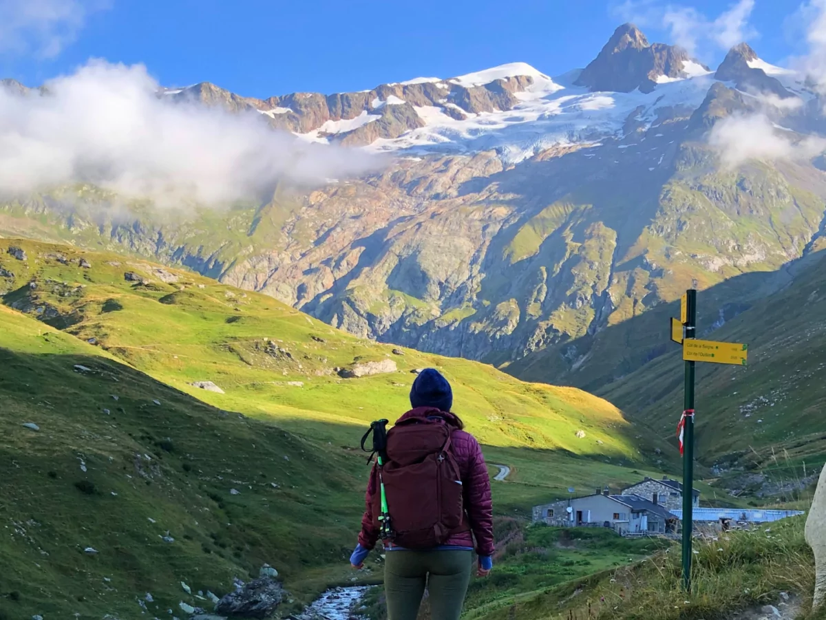 A Wildland Trekking guest taking in the view of the Alps hiking the Tour du Mont Blanc