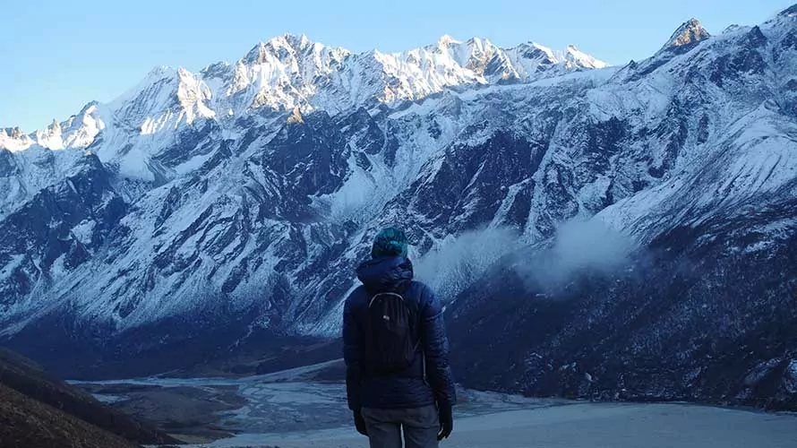 Wildland Trekking guide looking at the Himalayas on the Langtang Valley Trek