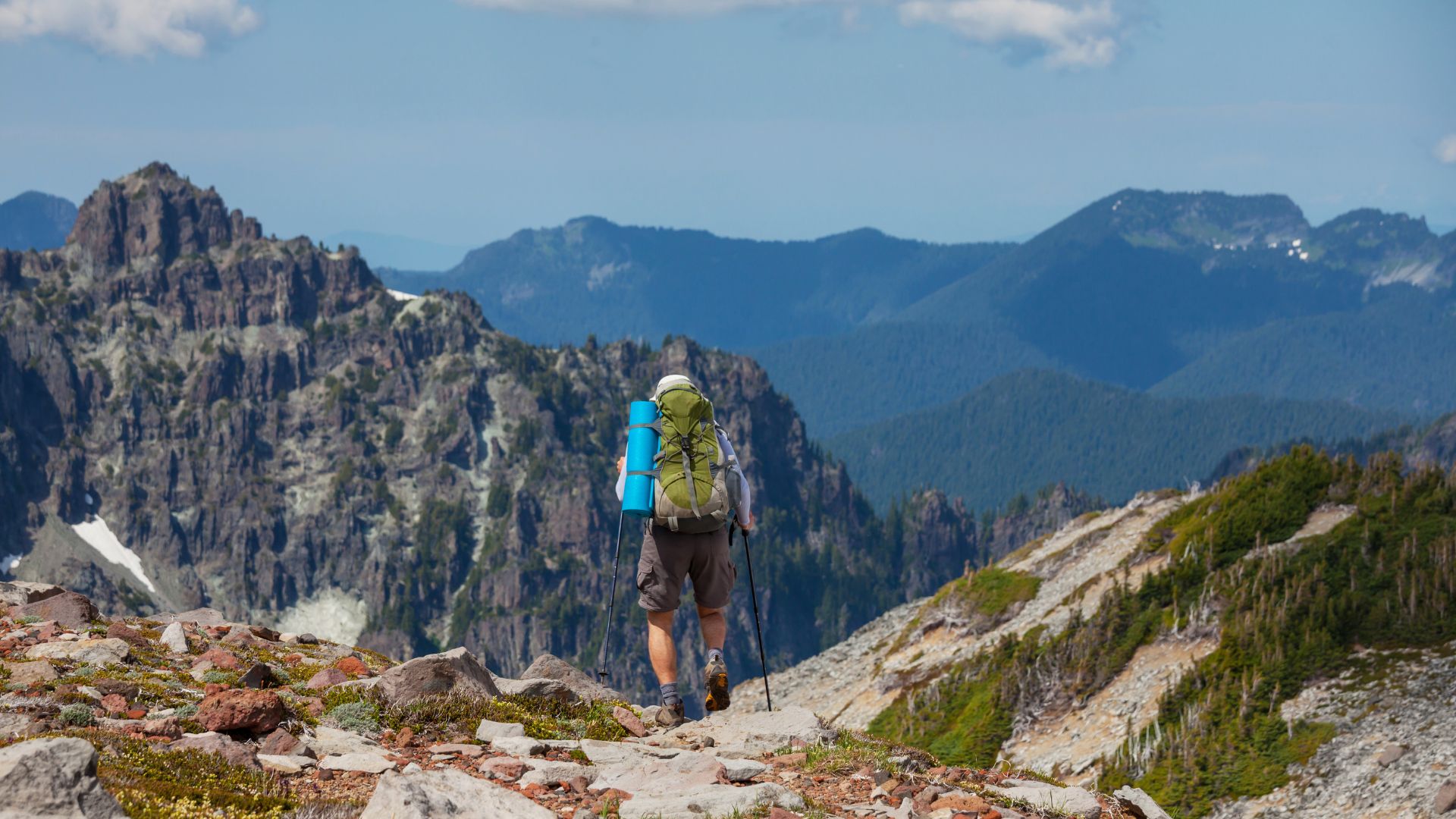 A hiker journeys into the mountains of North Cascades National Park