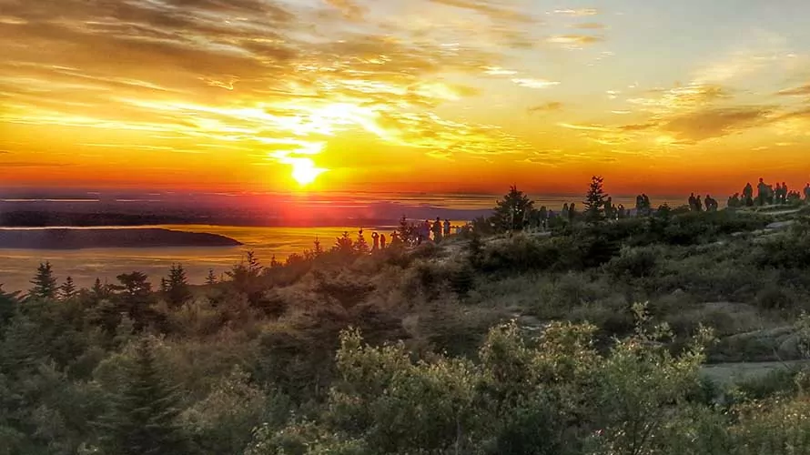 One tradition in Acadia National Park is for visitors to rise before the sun and make a pilgrimage by driving to the top of Cadillac Mountain for sunrise.