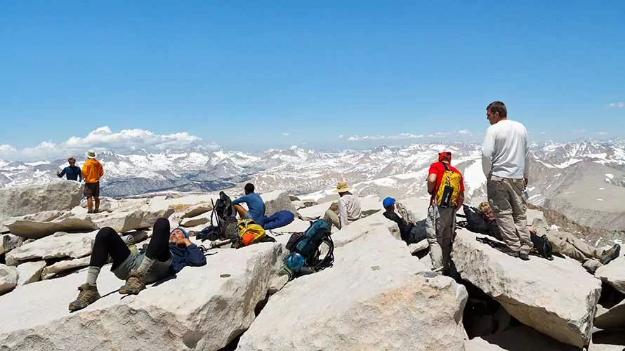 Hikers rest after a strenuous climb on the summit of Mount Whitney.