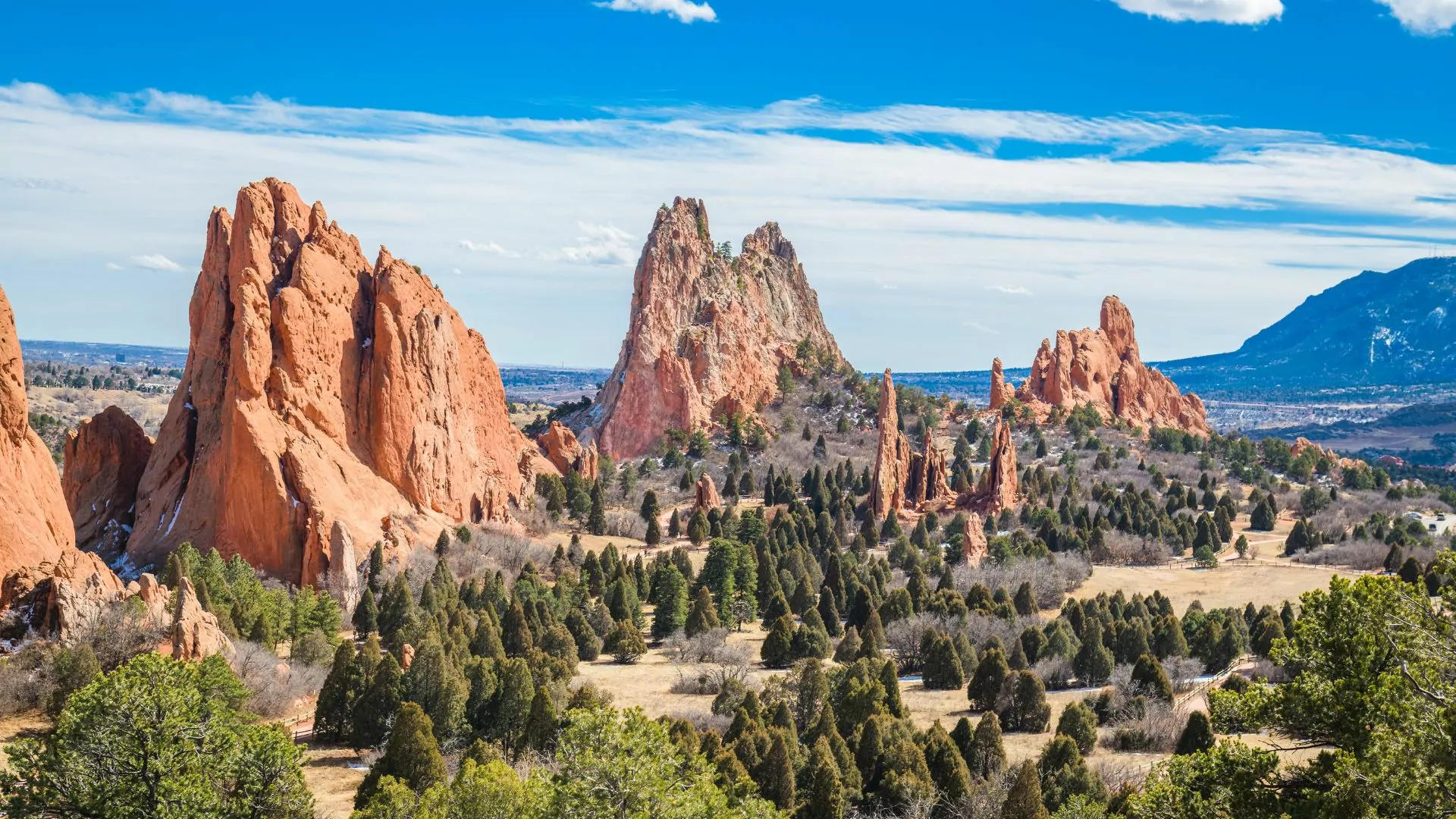Tall d rock formations rise out of pine forests at Garden of the Gods park in Colorado Springs, Colorado
